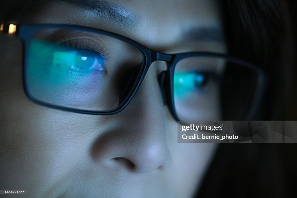 Woman wearing glasses looking monitor