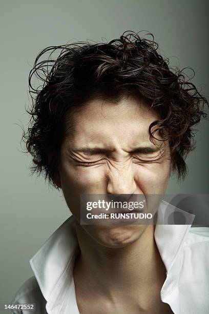 portrait of young man - squinting stock pictures, royalty-free photos & images