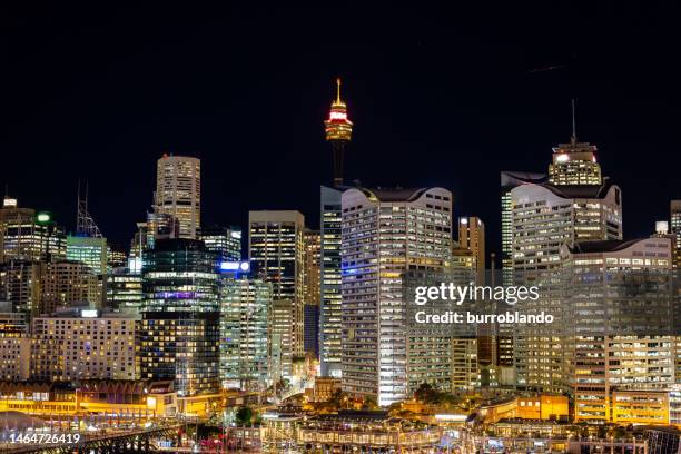 a night shot of sydney's cdb with all the lights on at night time from darling habrour - vivid sydney stock pictures, royalty-free photos & images