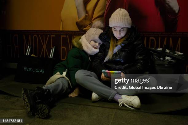 Woman and child take shelter in a metro station during an air alert on February 10, 2023 in Kyiv, Ukraine. On February 10, an air alert was announced...