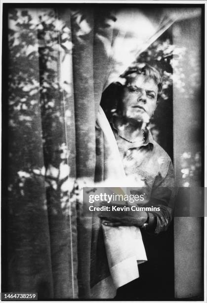 English comedian Eddie Izzard looking through a window, London, October 1993.