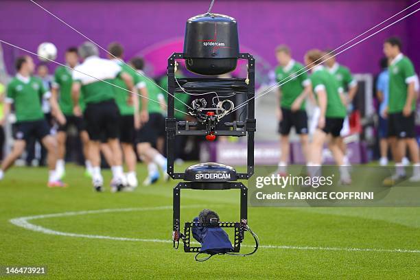 Spidercam" TV remote camera operates during a training session of the Irish team at the municipal stadium in Poznan on June 12, 2012 on the eve of...