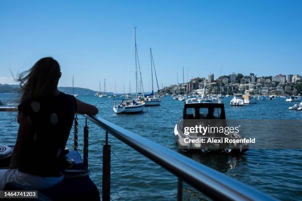 Woman looks out over at the marina in Double Bay on February 10, 2023 in Sydney, Australia. On July 6, 2022 the Australian government lifted all...