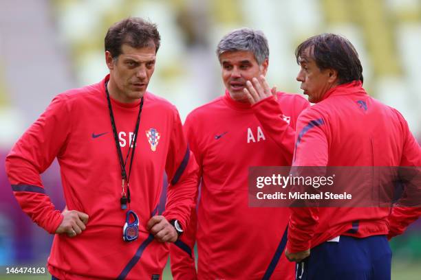 Slaven Bilic coach of Serbia looks on alongside assistants Aljosa Asanovic and Nikola Jurcevic of Croatia during a UEFA EURO 2012 training session at...