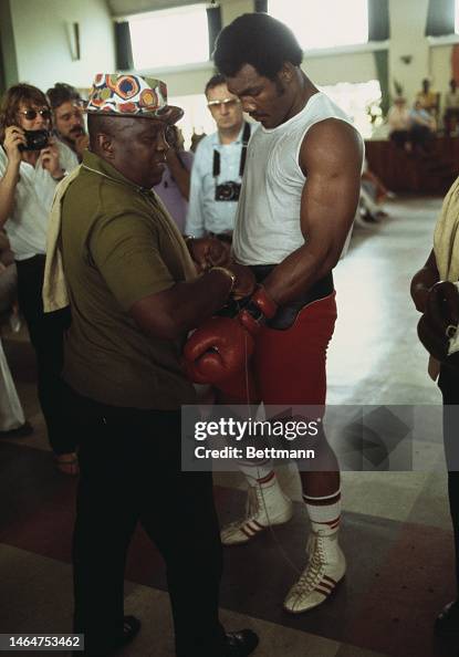 George Foreman Style Heavyweight champion George Foreman has his boxing glove removed by ...