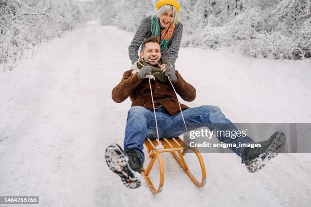 fun couple on a sled - sled push stock pictures, royalty-free photos & images