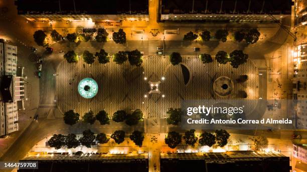 aerial view of pedro iv square or rossio square in the city of lisbon, portugal, at night - almeida theatre stock pictures, royalty-free photos & images