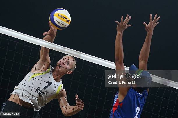 Alexey Kuleshov of Kazakhstan competes against Fahriansyah Fahriansyah of Indonesia during the Beach Volleyball Men's semifinal match on Day 1 of the...