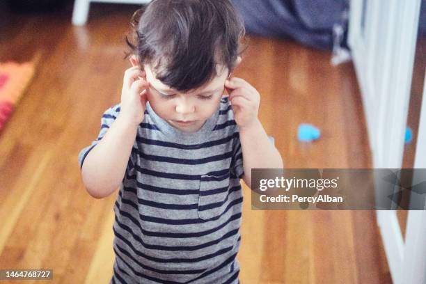 toddler with hands covering ears - hands covering ears stock pictures, royalty-free photos & images