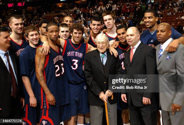 Legendary Basketball Coach John Wooden joined players from Saint Mary's College in Morgana, CA during trophy presentation celebration after winning...