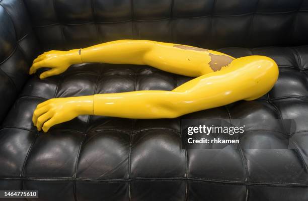 yellow mannequin arms on black sofa, playa blanca, lanzarote, canary islands, spain - mannequin arm stock pictures, royalty-free photos & images