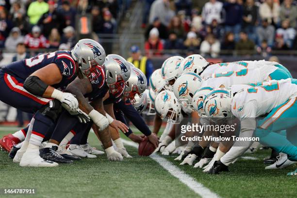 The Miami Dolphins and the New England Patriots line up for the snap at the line of scrimmage during the game at Gillette Stadium on January 01, 2023...