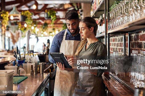 Tablet, bartender or small business people for communication, networking or online order check. Research, planning startup or teamwork for inventory checklist, stock management or social media review Tablet, bartender or small business people for communication, networking or online order check. Research, planning startup or teamwork for inventory checklist, stock management or social media review