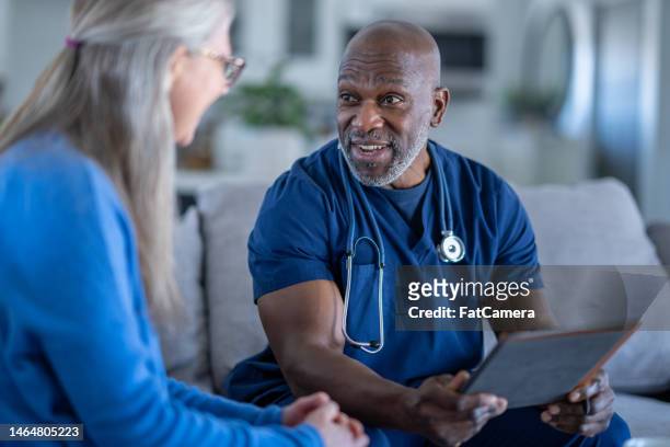 homecare nurse with a patient - doctor and patient talking stock pictures, royalty-free photos & images