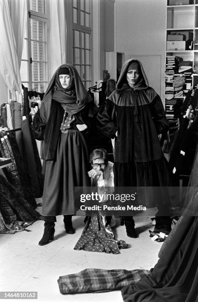 Yves Saint Laurent, Khirat Young and a model pose for a photo during a fitting for his fall 1977 Haute Couture collection.