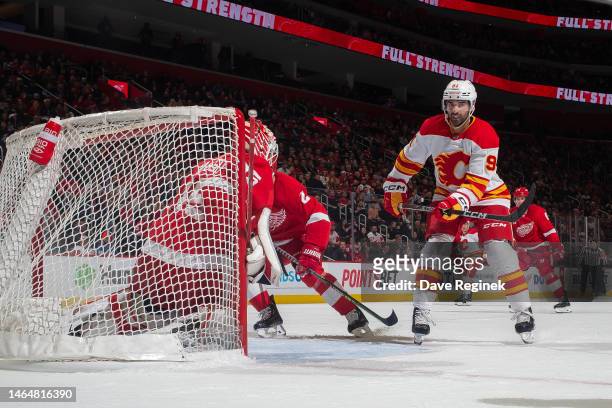 Nazem Kadri of the Calgary Flames follows the play in front of Ville Husso of the Detroit Red Wings during the third period of an NHL game at Little...