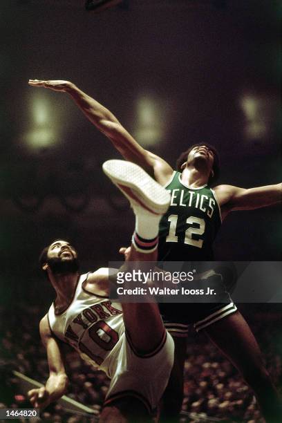 Walt Frazier of the New York Knicks battles for a rebound against the Boston Celtics during the NBA game at Madison Square Garden in New York, NY....