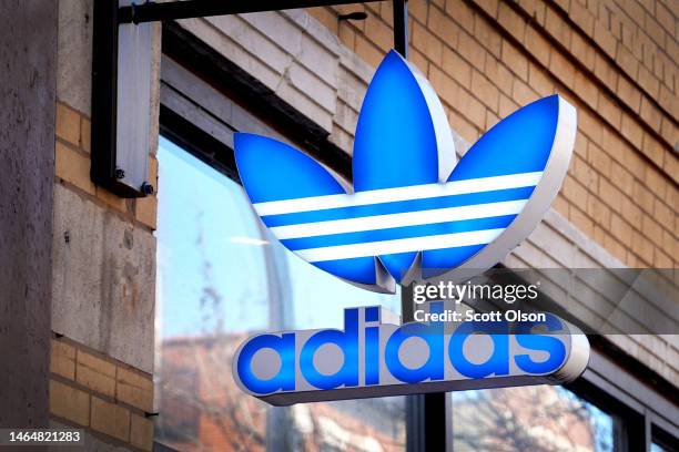 Sign hangs outside of an Adidas store on February 10, 2023 in Chicago, Illinois. Adidas is expecting to report a loss in 2023 after terminating a...