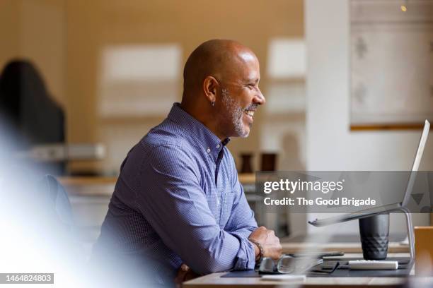 happy businessman doing video call through laptop at office - smart casual laptop stock pictures, royalty-free photos & images