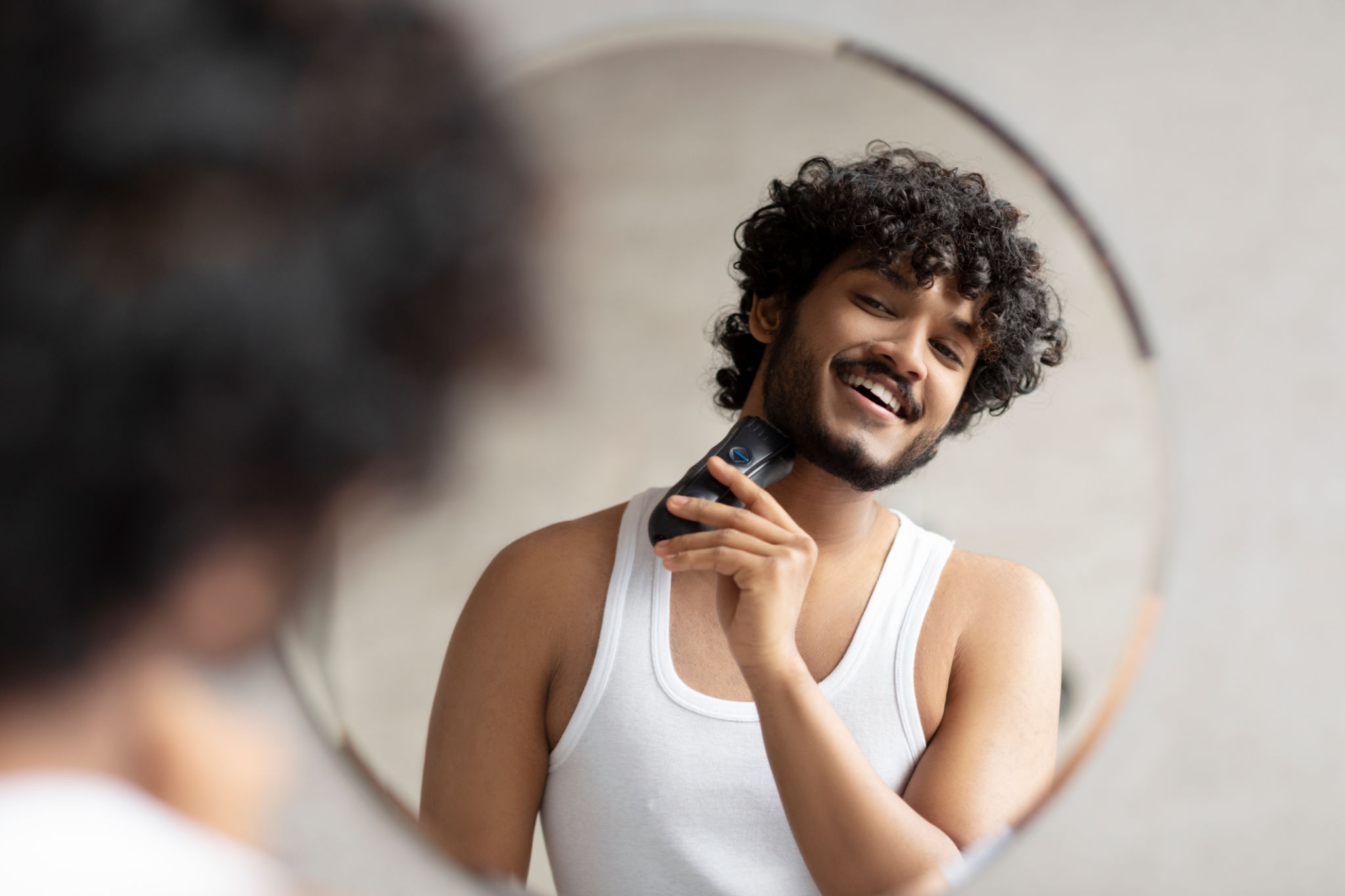 man trimming beard