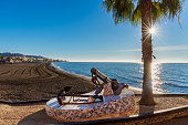 Rincon de la Victoria beach in Malaga, with a monument with ship anchors on the promenade in memory of its seafaring past.
