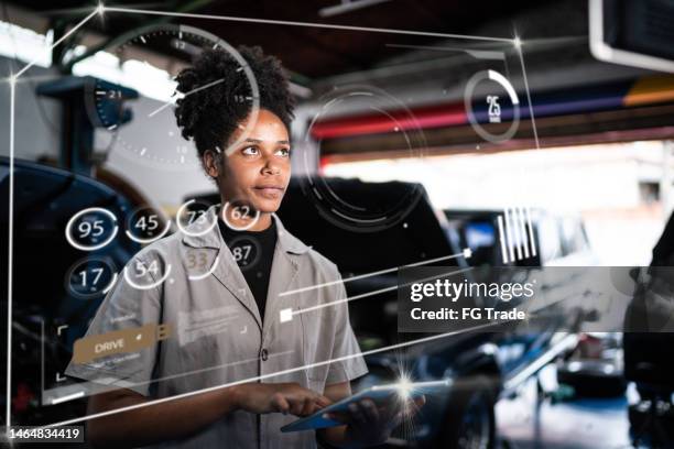 young woman using futuristic user interface on the repair shop - trainee program stock pictures, royalty-free photos & images