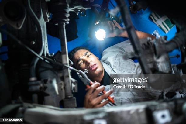 auto mechanic man repairing the car on a repair shop - plier stock pictures, royalty-free photos & images
