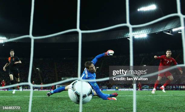 Cristiano Ronaldo of Portugal scores his team's second goal past Maarten Stekelenburg of Netherlands during the UEFA EURO 2012 group B match between...