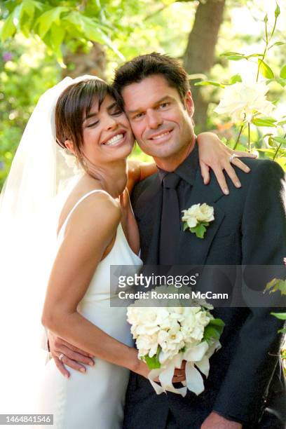Actors Lisa Rinna and Harry Hamlin share a laugh in their garden where they were married on March 29, 1997 in Beverly Hills, California.