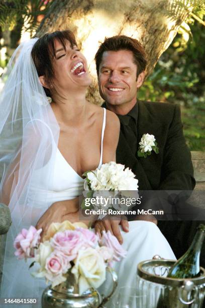 Actors Lisa Rinna and Harry Hamlin share a laugh in their garden where they were married on March 29, 1997 in Beverly Hills, California.