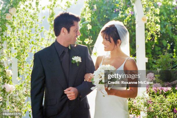 Actors Lisa Rinna and Harry Hamlin walk through the archway in their garden where they were married on March 29, 1997 in Beverly Hills, California.