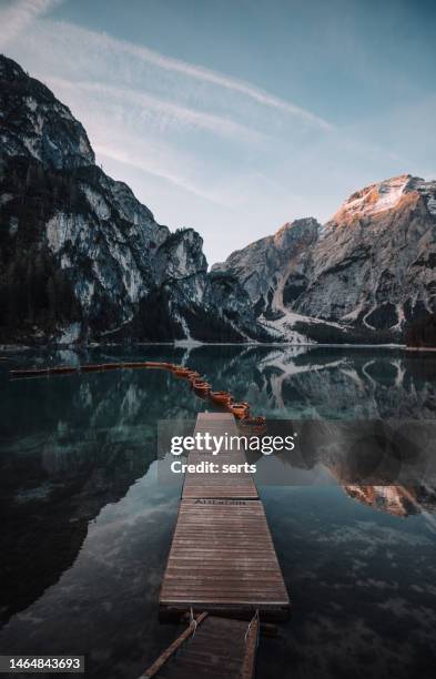 lago di braies lake and seekofel peak at sunrise, dolomites, italy - blue sailboat stock pictures, royalty-free photos & images