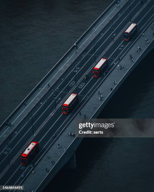 aerial view of london bridge and red double-decker buses in london, uk - aerial shots stock pictures, royalty-free photos & images