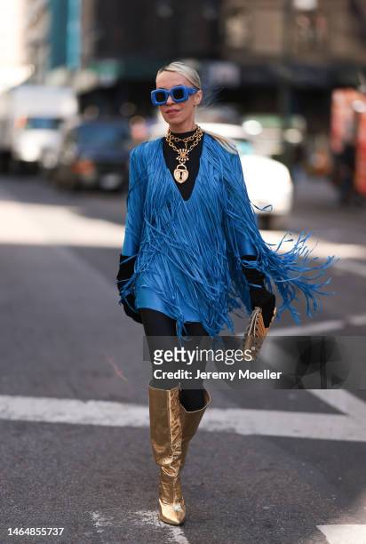 Denisa Palsha seen wearing a Balmain blue fringe mini dress, Cult Gaia gold shell bag, Loewe blue statement glasses, black velvet gloves,...