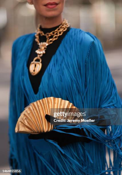 Denisa Palsha seen wearing a Balmain blue fringe mini dress, Cult Gaia gold shell bag, Loewe blue statement glasses, black velvet gloves,...