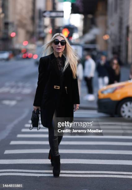 Corina Mihaila Larpin seen wearing Schiaparelli black velvet coat, Chanel transparent black blouse, Lady Dior black leather bag, Stefere white gold...