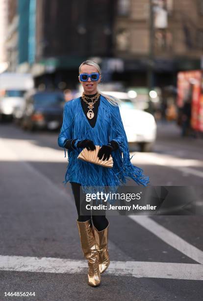 Denisa Palsha seen wearing a Balmain blue fringe mini dress, Cult Gaia gold shell bag, Loewe blue statement glasses, black velvet gloves,...