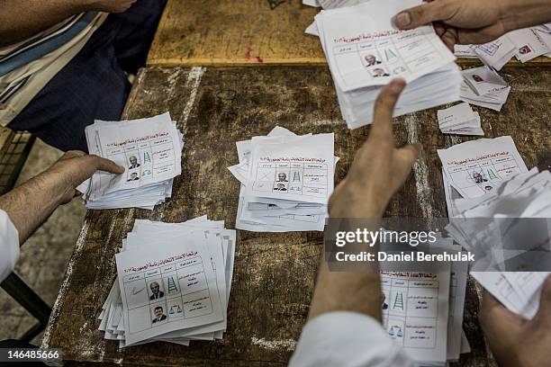 Egyptian election workers count votes at a polling station on June 17, 2012 in Cairo, Egypt. Egyptians went to the polls today for the second round...