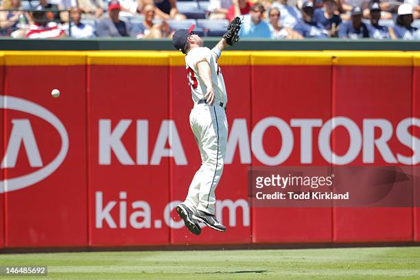 Matt Diaz of the Atlanta Braves leaps for the ball as it tips off his glove during the interleague game against the Baltimore Orioles at Turner Field...