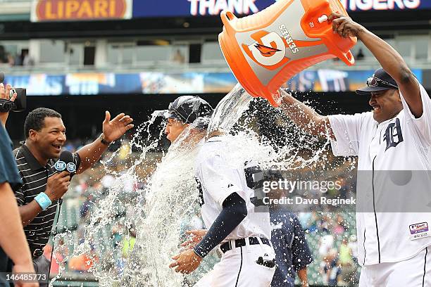 Quintin Berry of the Detroit Tigers has a bucket of water dumped on him by teammate Jose Valverde while being interviewed by Fox reporter Trevor...