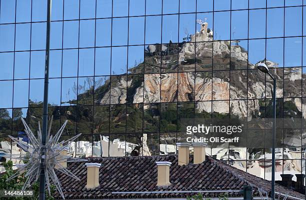 Lycabettus hill and buildings in central Athens are reflected in a mirrored office block on June 17, 2012 in Athens, Greece. The conservative,...