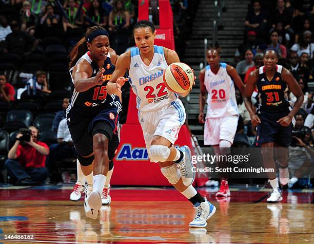 Armintie Price of the Atlanta Dream drives ahead of Asjha Jones of the Connecticut Sun at Philips Arena on June 17, 2012 in Atlanta, Georgia. NOTE TO...