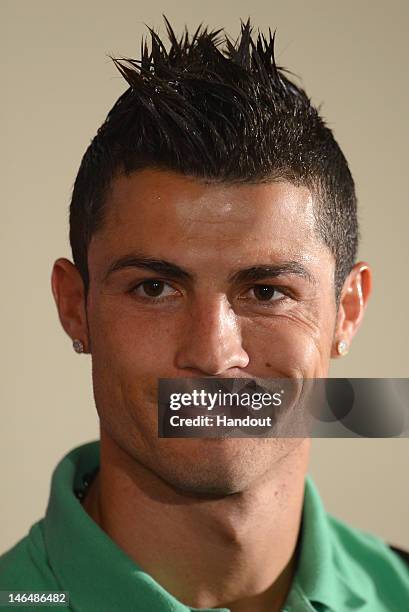 In this handout image provided by UEFA, Cristiano Ronaldo of Portugal talks to the media during a press conference after the UEFA EURO 2012 Group B...