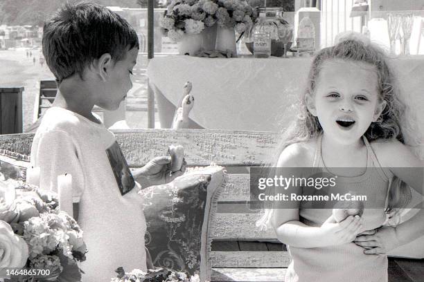 Tiffany Trump poses with another child at a baby shower for Lisa Rinna on the beach on April 19, 1998 in Malibu, California