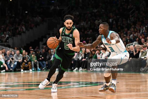 Derrick White of the Boston Celtics dribbles the ball against Terry Rozier of the Charlotte Hornets during the first quarter of the game at TD Garden...