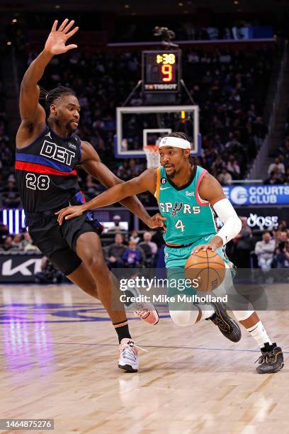 Devonte' Graham of the San Antonio Spurs dribbles up the court against Isaiah Stewart of the Detroit Pistons in the second quarter of a game at...