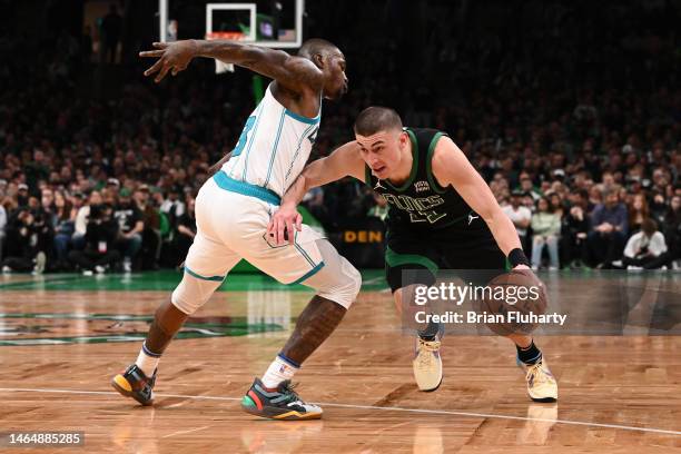 Payton Pritchard of the Boston Celtics dribbles the ball against Terry Rozier of the Charlotte Hornets during the third quarter of the game at the TD...