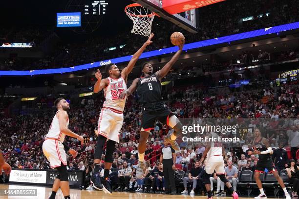 Justin Holiday of the Houston Rockets attempts a layup past Orlando Robinson of the Miami Heat during the first half at Miami-Dade Arena on February...
