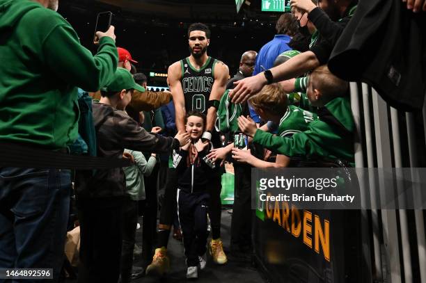 Jayson Tatum of the Boston Celtics walks off of the court with his son Deuce after a game against the Charlotte Hornets at the TD Garden on February...