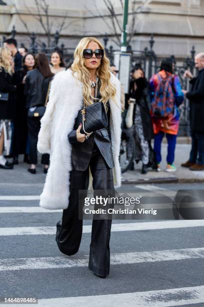 Rachel Zoe wears white fur coat, black Chanel bag, black leather pants, blazer, sunglasses outside Rodarte during New York Fashion Week on February...